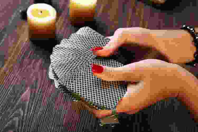 an woman fanning go a decking out cards